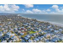 Aerial view of a house near the beach, showcasing the surrounding neighborhood and waterfront at 210 Willow Ave, Anna Maria, FL 34216