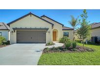 House exterior showcasing a two-car garage and well-manicured lawn at 221 Brindisi Cir, Nokomis, FL 34275