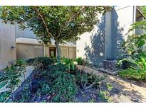 Well-manicured landscaping surrounds the entrance to this condo at 360 Pine Run Dr, Osprey, FL 34229