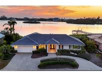 Luxury waterfront home with circular driveway, offering sunset views at 419 Yacht Harbor Dr, Osprey, FL 34229