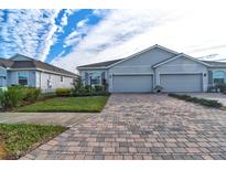 Two-story home with gray exterior, two-car garage and paver driveway at 4337 Sunmill Ct, Lakewood Ranch, FL 34211