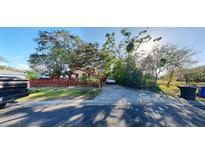 Front view of a charming house with a red fence and driveway at 4352 17Th S Ave, St Petersburg, FL 33711