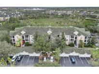 Aerial view of condo building, showing building, parking lot and landscaping at 5180 Northridge Rd # 211, Sarasota, FL 34238