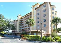 Exterior of a large condominium building with palm trees and landscaping at 5531 Cannes Cir # 802, Sarasota, FL 34231