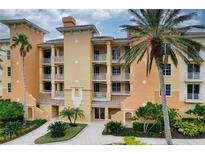 Three-story building with balconies, palm trees, and manicured landscaping at 6450 Watercrest Way # 304, Lakewood Ranch, FL 34202