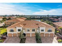 Aerial view of townhouses with lake and lush landscaping at 7325 Skybird Rd, Bradenton, FL 34209