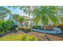 Charming home exterior with lush landscaping, walkway, and inviting entrance at 7703 Whitebridge Gln, University Park, FL 34201