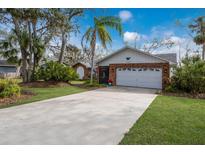 Brick ranch home with attached garage and mature landscaping at 8009 55Th E St, Palmetto, FL 34221