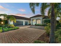 Beautiful two-story home with a tile roof and lush landscaping at 13823 Swiftwater Way, Bradenton, FL 34211