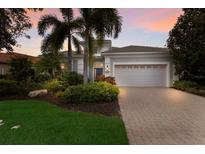 Attractive single-story home with landscaped yard and gray garage door at 14333 Stirling Dr, Lakewood Ranch, FL 34202