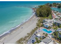 Aerial view of beachfront property with pool and lush landscaping at 1555 Tarpon Center Dr # 261, Venice, FL 34285