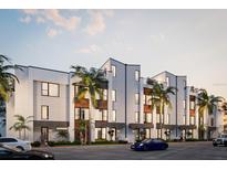 Modern multi-unit building with sleek design and palm trees at 162 Audubon Pl, Sarasota, FL 34237