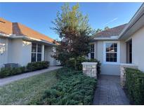 Well-maintained landscaping surrounds this charming villa at 1910 Scarlett Ave, North Port, FL 34289