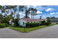 Attractive single story home with red tile roof and lush landscaping at 2291 Pueblo Ln # V46, Sarasota, FL 34231