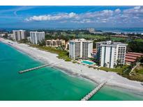 Aerial view of beachfront condo community with pool and ocean access at 2301 Gulf Of Mexico Dr # 52N, Longboat Key, FL 34228