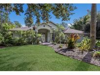 Single-story house with a lush green lawn and mature trees at 3395 Hardee Dr, Venice, FL 34292