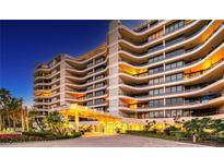 Luxury condo building exterior with well-lit entrance and landscaping at 415 L Ambiance Dr # A401, Longboat Key, FL 34228