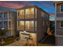 Two-story house with a garage and a paved driveway, at dusk at 4238 Marina View Way, Cortez, FL 34215