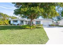 Charming ranch home with mature landscaping and a spacious front yard at 4515 Falcon Ridge Dr, Sarasota, FL 34233