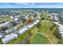 Aerial view of community showing building location, golf course, and pool at 452 Cerromar Rd # 176, Venice, FL 34293