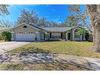 Single-story house with attached garage and well-maintained lawn at 4822 30Th Street E Ct, Bradenton, FL 34203