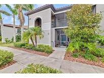 Exterior view of condo building showcasing landscaping and building facade at 6705 Grand Estuary Trl # 201, Bradenton, FL 34212