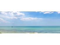 Stunning ocean view with clear water and a boat in the distance at 7314 Point Of Rocks Rd, Sarasota, FL 34242