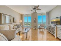 Bright living room with water views, hardwood floors, and ample natural light at 1233 N Gulfstream Ave # 502, Sarasota, FL 34236