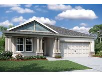 One-story home with light taupe siding, gray roof, and a two-car garage at 19591 Fort King Run, Brooksville, FL 34601