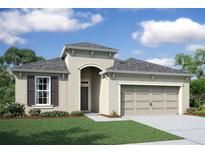 One-story home with stucco exterior, two-car garage, and landscaped lawn at 19649 Fort King Run, Brooksville, FL 34601