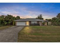 One-story home with attached garage and spacious yard at 230 Salisbury St, Port Charlotte, FL 33954