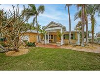 Inviting coastal home with a spacious front porch and lush landscaping at 306 55Th St, Holmes Beach, FL 34217