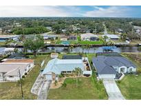 Aerial view of canal front homes with private pools and boat docks at 3438 Yukon Dr, Port Charlotte, FL 33948