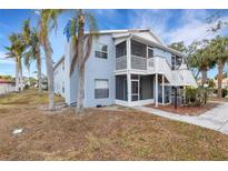 Light blue two-story condo with balcony, screened porch, and palm trees at 3815 59Th W Ave # 3815, Bradenton, FL 34210