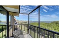 Enjoy water views from this cozy balcony with railings and chair at 4009 Catalina Dr # 178, Bradenton, FL 34210