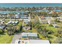 Aerial view of a light blue house with a pool, near the ocean at 401 Shore Rd, Nokomis, FL 34275