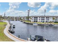 Aerial view of waterfront community with boats and lush landscaping at 4350 Chatham Dr # 208, Longboat Key, FL 34228