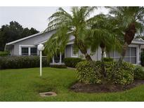 Gray house with palm trees and landscaped lawn at 4527 Fern Dr # 26, Bradenton, FL 34208