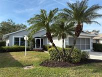 Single-story home with grey exterior, palm trees, and well-manicured lawn at 4527 Fern Dr # 26, Bradenton, FL 34208