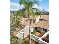 Attractive condo complex with a courtyard and lush landscaping at 4555 Forest Wood Trl # 23, Sarasota, FL 34241