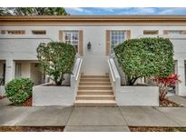 Front view of condo building with stairs and landscaping at 5248 Marshfield Ln # 2, Sarasota, FL 34235