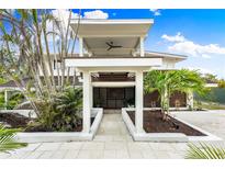 Two-story home with modern design, tropical landscaping, and walkway at 541 Edlee Ln, Longboat Key, FL 34228