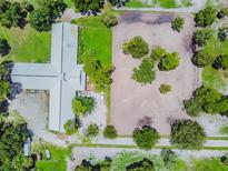 Aerial view showing home, barn, riding arena, and lush grounds at 1101 Anclote Blvd, Tarpon Springs, FL 34689