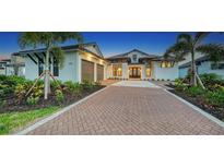Stunning two-story home with a three-car garage and brick driveway at 1210 Blue Shell Loop, Sarasota, FL 34240
