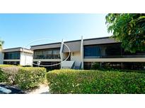 Exterior view of condo building with landscaping and balcony at 1737 Bonitas Cir # 1724D, Venice, FL 34293