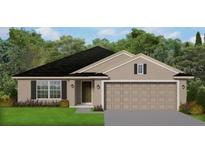 Single-story home with a two-car garage and landscaping at 2679 Averland Loop, North Port, FL 34287