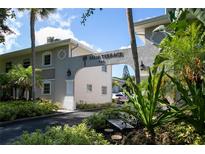 Palm Terrace 324 building exterior, featuring a landscaped entryway and parking at 521 W Venice Ave # 22, Venice, FL 34285