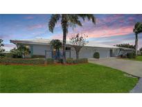 Attractive condo exterior featuring a landscaped lawn and two-car garage at 6810 9Th W Ave, Bradenton, FL 34209