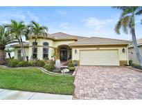 Beautiful one-story home with a tile roof, two-car garage, and lush landscaping at 1227 Tuscany Blvd, Venice, FL 34292