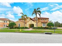 Luxury Mediterranean home with tile roof, three-car garage, and lush landscaping at 206 Bella Vista Ter # 29B, North Venice, FL 34275